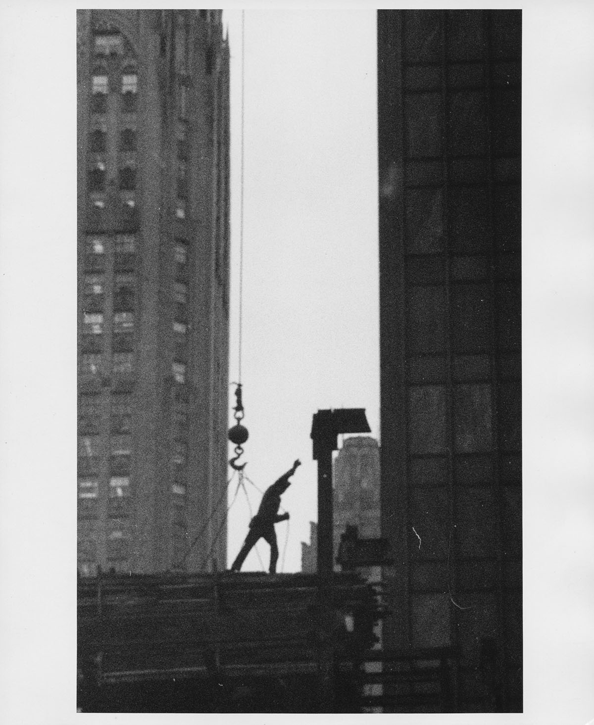 Construction worker hoisted by crane, 1957, Anthony Angel