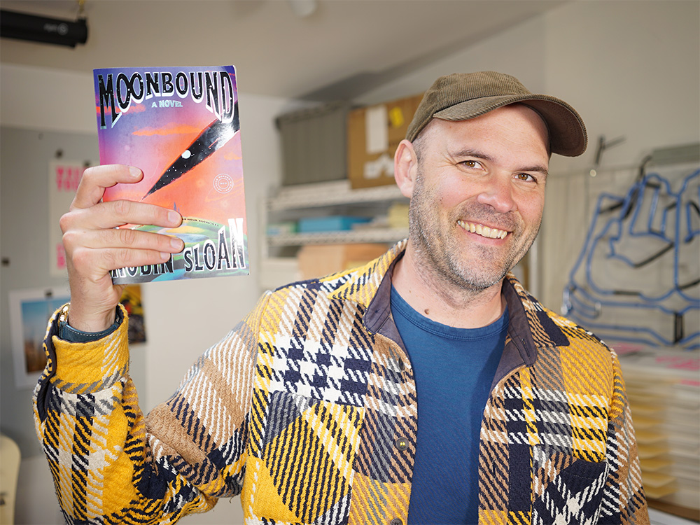 A picture of a smiling Robin holding an advance copy of his book.
