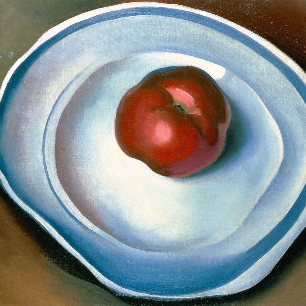 A cartoonishly red apple on a simple plate, white with a blue stripe around its circumference.